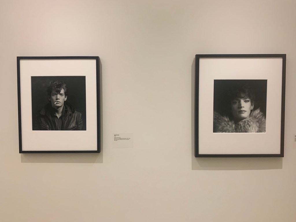 picture of Guggenheim exhibition depicting two separate framed portraits of the artist